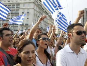 Protesters outside the Greek parliament chant and rally against austerity