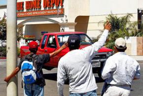 Laborers hope for a day's work in a Home Depot parking lot