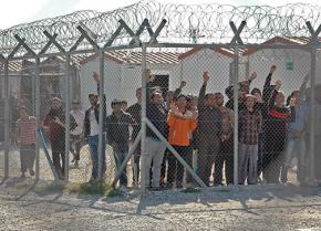 Immigrant prisoners at the Amygdaleza Detention Center greet a protest march calling for the center to be closed